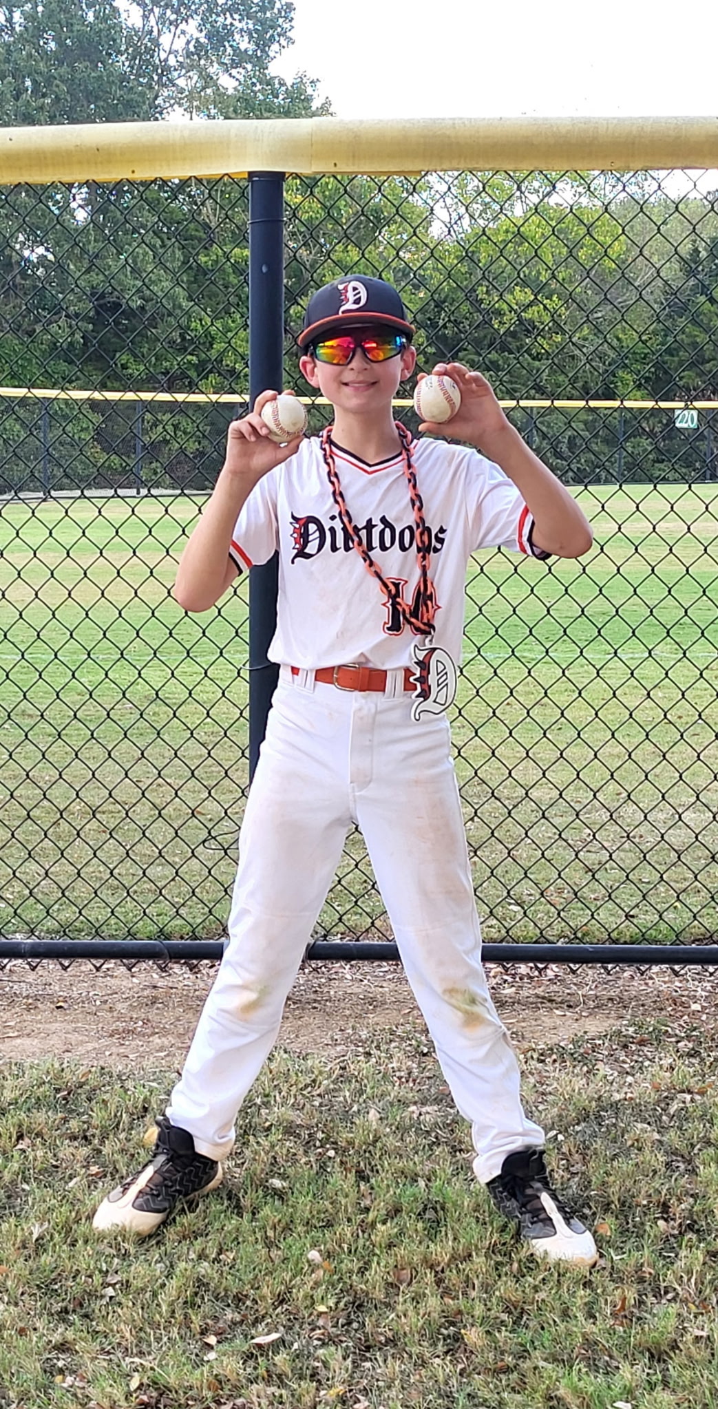 Dirt Dogs player posing with baseballs