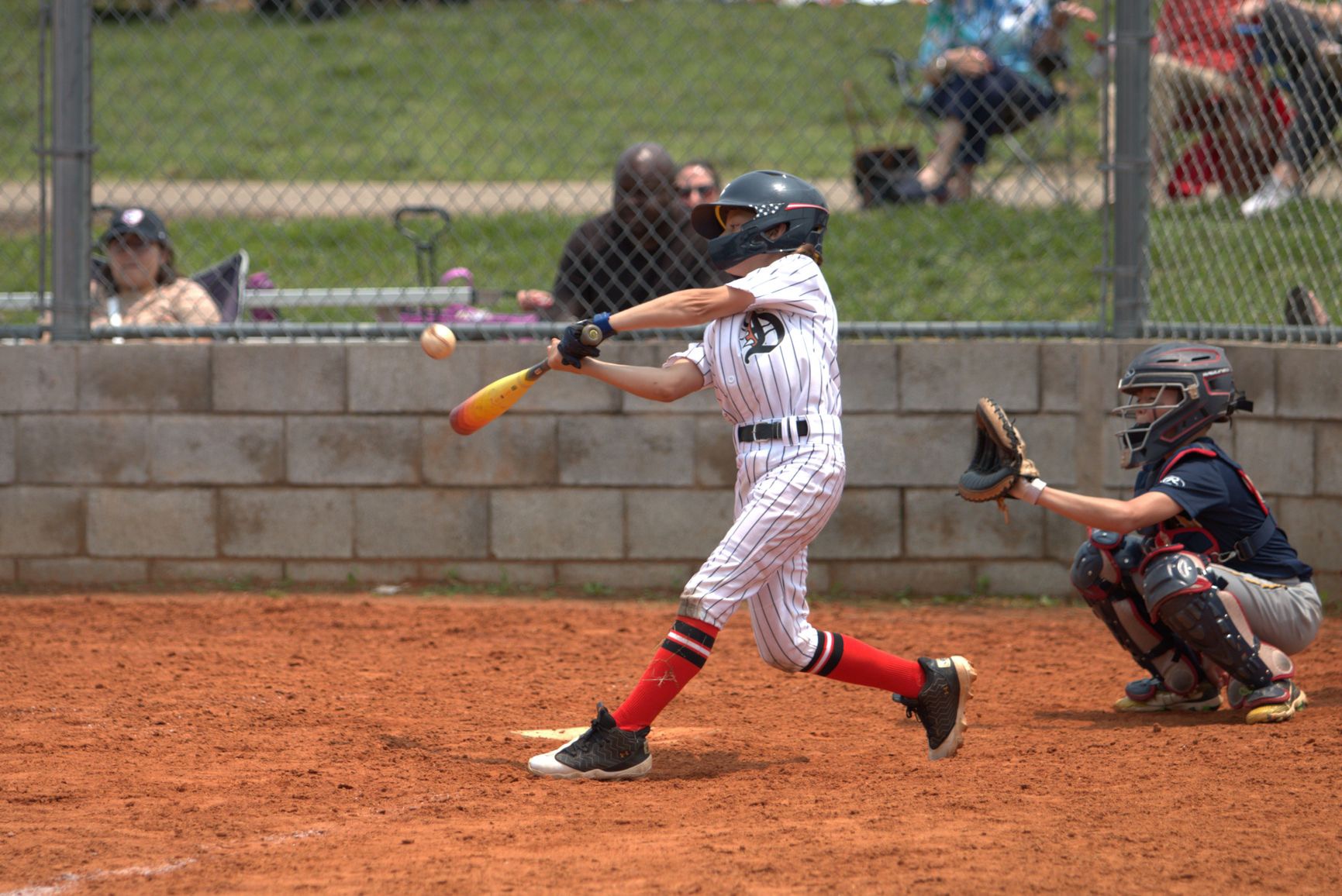 Dirt Dogs player making contact at the plate